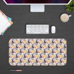 Desk pad with a white background featuring a pattern of small blue and purple flowers or geometric shapes. Desk Pad kept on a gray background