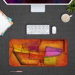 Infidu Artistic Desk Mat with abstract rectangular and trapezoidal shapes in warm tones of orange, red, purple, and yellow. Desk Pad with Design Kept on a computer table