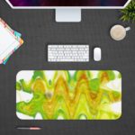 Infidu Artistic Desk Mat featuring a wave abstract design in lime green and yellow, with white accents. Ideal for adding a creative touch to any desk. Design Kept on a computer table