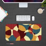 Infidu Artistic Patterns Desk Pad with overlapping curved shapes in maroon, beige, teal, and brown. Desk Pad with Design Kept on a computer table