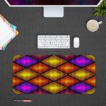 Infidu Artistic Patterns Desk Mat with 3D overlapping diamond shapes in gradient shades of purple, orange, and yellow. Desk Pad with Design Kept on a computer table