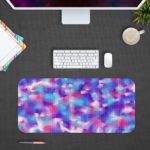 Infidu Artistic Patterns Desk Pad with a multi-colored speckled design in blue, pink, purple, and white, resembling a watercolor effect. Desk Pad with Design Kept on a computer table