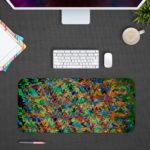 Infidu Artistic Patterns Desk Pad with a multi-colored abstract design featuring zigzagging lines and pixelated shapes. desk pad Design Kept on a computer table