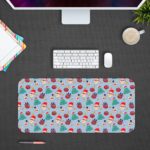 Infidu Christmas Desk Pad with playful snowflakes, Christmas trees, and ornaments on a light blue background. Design Kept on a computer table