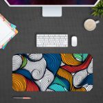 Infidu Desk Pad with colorful wave patterns in orange, blue, white, and red. Desk Pad in computer table