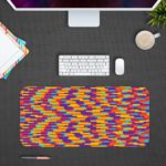 Infidu Artistic Desk Pad with a colorful mosaic pattern of red, yellow, blue, purple, and orange blocks arranged diagonally. Desk Pad with Design Kept on a computer table