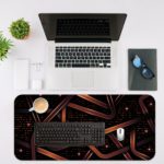 Infidu desk pad with a dark background, copper-colored ribbons, and glowing pinkish-purple lights, creating a sleek, modern look. Desk Mat with in laptop