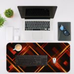 Desk pad with a black background and glowing golden lines forming a diamond pattern. Desk Mat with a laptop