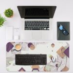 Infidu Desk Pad with abstract geometric shapes in white, beige, and light purple on a white background. Desk Mat with a laptop