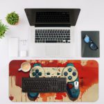 Infidu Tech Fusion With Joystick Desk Pad featuring an artistic game controller in orange and red, with a colorful sandal orange background and vibrant paint splashes Desk Mat with an Apple Computer