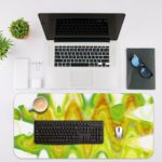 Infidu Artistic Desk Mat featuring a wave abstract design in lime green and yellow, with white accents. Ideal for adding a creative touch to any desk. Desk Mat with an Apple Laptop