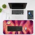 Infidu Artistic Animated Desk Pad with a swirling marbled pattern in pink, white, and red. Desk Mat with an Apple Laptop