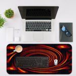 Infidu Artistic Patterns Desk Pad features a swirling red spiral on a deep black background, creating a dramatic vortex effect. Desk Mat with an Apple Laptop