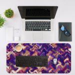 Infidu Artistic Patterns Desk Pad with a purple and pink wavy pattern, accented with white and dark red zigzag lines. Desk Mat with an Apple Laptop