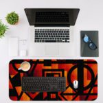 Infidu Artistic Patterns Desk Pad with bold red, orange, and black geometric shapes for a modern and striking look. Desk Mat with an Apple laptop