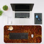 Infidu Artistic Patterns Desk Pad with deep red and orange background and textured abstract designs. Desk Mat with an Apple laptop