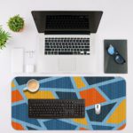 Infidu Artistic Pattern Desk Pad - Blue background with abstract shapes in orange, yellow, and light blue Desk Mat with in laptop