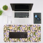 The cute panda desk mat has adorable panda faces and green leaves on a white and sandal background. Desk Mat with in laptop