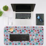 Infidu Christmas Desk Pad with playful snowflakes, Christmas trees, and ornaments on a light blue background. Desk Mat with in laptop