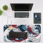 Infidu Artistic Desk Mat with Japanese Ocean vector art in blue and red waves on a white background. Desk Mat with an Apple Laptop