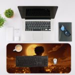 Desk pad featuring an anime-style silhouette of a person facing a glowing full moon with a nighttime cityscape background in warm colors. Desk Mat with an Apple Laptop