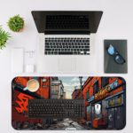 Desk pad showing a narrow street with colorful buildings and graffiti, creating a dynamic urban atmosphere. Desk Mat with an Apple Laptop