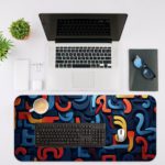 Infidu Desk Pad with a funky pattern of abstract curved shapes in blue, red, and yellow. Desk Mat with in laptop