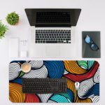 Infidu Desk Pad with colorful wave patterns in orange, blue, white, and red. Desk Mat with in laptop