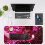 Desk pad featuring an anime character surrounded by vibrant pink and red tones with an abstract, energy-filled background. Desk Mat with an Apple Laptop