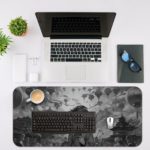 Desk pad featuring a ninja anime boy with a background of traditional Asian architecture and floating lanterns in grayscale. Desk Mat with an Apple Laptop