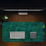 Blue-green swirled abstract design with fluid, wavy lines resembling water or marble. Desk Pad in computer table