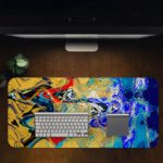 Infidu Artistic Desk Mat with dynamic swirling abstract pattern in yellow, red, and blue on a dark background. Desk Pad in computer table