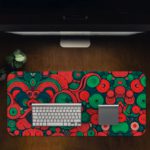 Desk pad with an abstract pattern of overlapping circles and swirls in red, green, and dark blue. Desk Pad in computer table