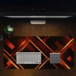 Desk pad with a black background and glowing golden lines forming a diamond pattern. Desk Pad in computer table