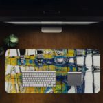 Infidu Artistic Desk Mat with abstract cityscape design in yellow and blue with white lines. Desk Pad in computer table