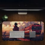 A Boy standing by train tracks with a red train and sunset in the background on the Infidu Artistic Desk Pad. Desk Pad in computer table