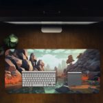 Rocky coastal scene with cliffs, boulders, and a flowing river in earthy oranges and cool blues. Desk Pad in computer table