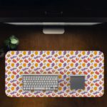 Desk pad with orange and yellow spots on a white background, featuring a playful and lively design. Design Kept on a computer table