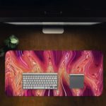 Infidu Artistic Animated Desk Pad with a swirling marbled pattern in pink, white, and red. Desk Pad in computer table