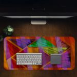 Infidu Artistic Animated Desk Pad with overlapping triangular and rectangular shapes in purple, red, green, orange, and yellow. Desk Pad in computer table