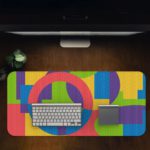 Infidu Artistic Patterns Desk Pad with colorful geometric shapes in pink, green, yellow, blue, and purple. Desk Pad in computer table