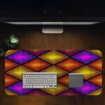 Infidu Artistic Patterns Desk Mat with 3D overlapping diamond shapes in gradient shades of purple, orange, and yellow. Desk Pad in computer table