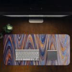 Infidu Artistic Patterns Desk Mat with smooth, flowing marble-like design in soft blue, white, and gray with light brown accents. Desk Pad in computer table