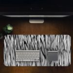 Infidu Artistic Patterns Desk Pad with vertical black and white lines creating a dense, forest-like pattern and optical illusion effect. Desk Pad with Design Kept on a computer table