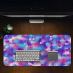 Infidu Artistic Patterns Desk Pad with a multi-colored speckled design in blue, pink, purple, and white, resembling a watercolor effect. Desk Pad in computer table