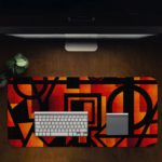 Infidu Artistic Patterns Desk Pad with bold red, orange, and black geometric shapes for a modern and striking look. Desk Pad in computer table