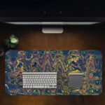 Infidu Artistic Patterns Desk Pad - Whispering Winds Abstract Art with colorful swirling lines on black background Design Kept on a computer table