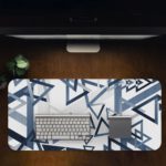 Infidu Artistic Patterns Desk Mat - White with blue and grey overlapping triangles Design Kept on a computer table