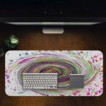 Infidu Artistic Desk Pad with a rainbow spiral and multicolored splatter on a white background. Desk Pad in computer table