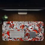 Red and gray desk pad with swirling, energetic shapes and doodle art. Desk Pad in computer table